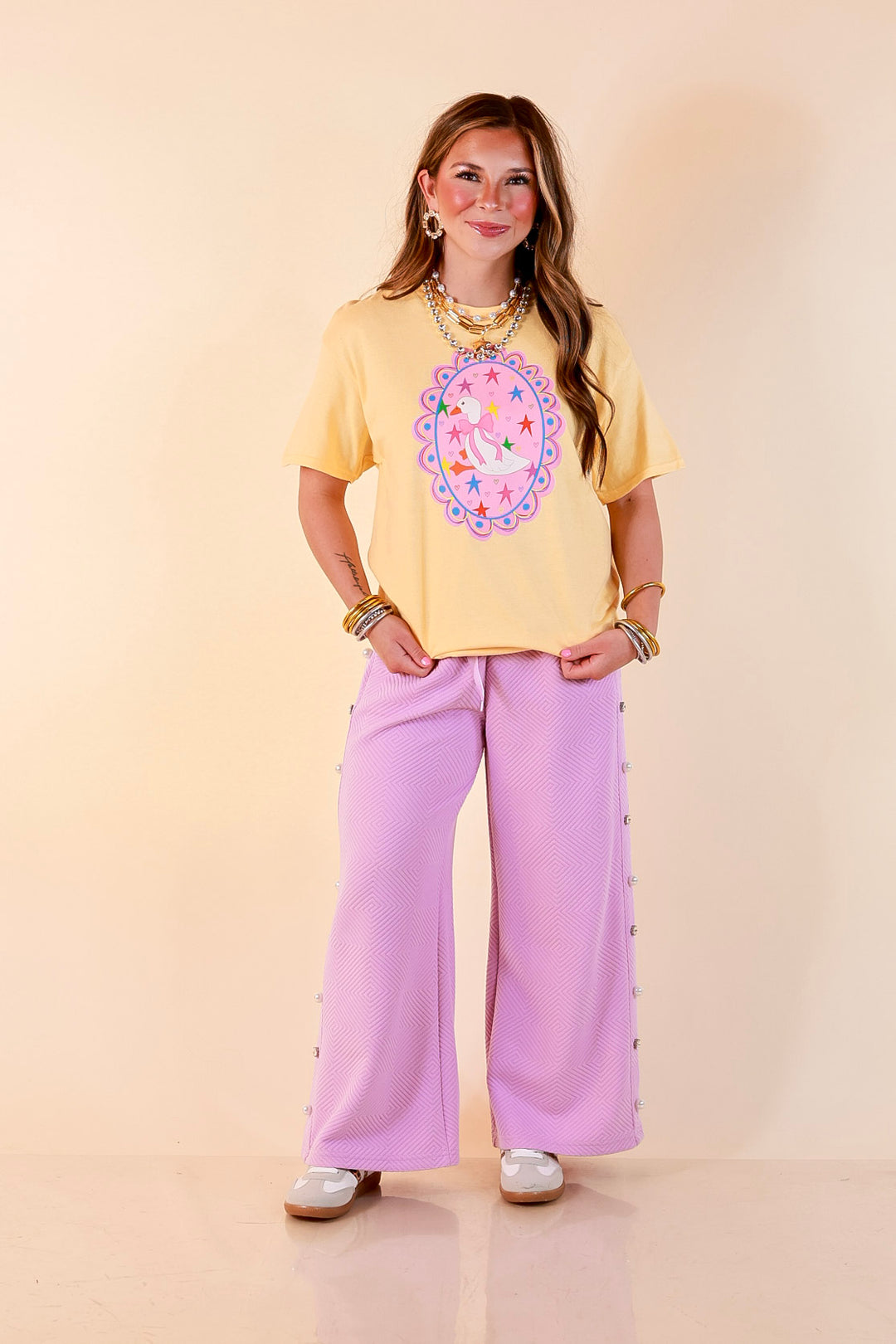 Goose on the Loose Whimsical Pink Background with Stars and Hearts Goose Printed Graphic Tee in Butter Yellow