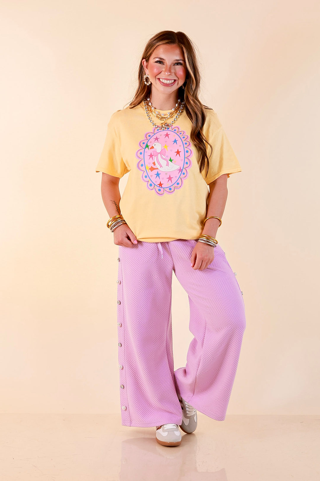 Goose on the Loose Whimsical Pink Background with Stars and Hearts Goose Printed Graphic Tee in Butter Yellow