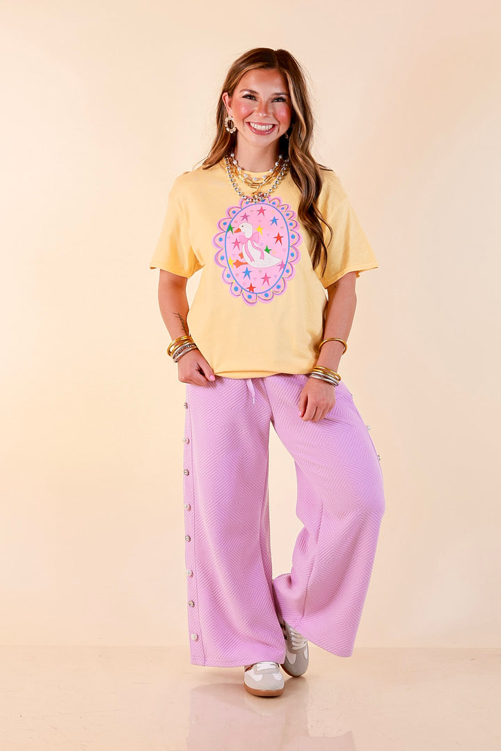 Goose on the Loose Whimsical Pink Background with Stars and Hearts Goose Printed Graphic Tee in Butter Yellow
