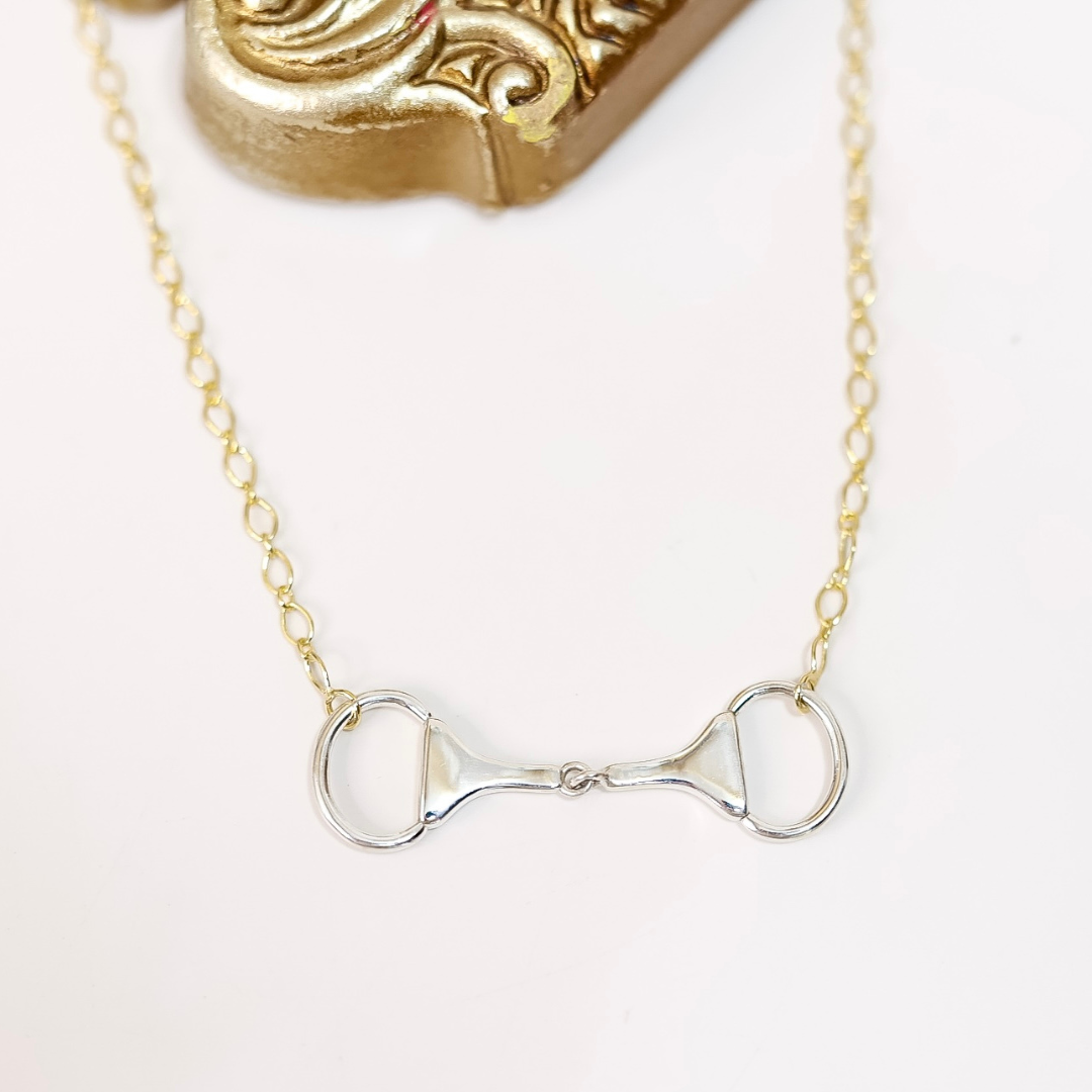 Close-up of Sterling Silver and 14K Gold plated horse bit necklace with snaffle bit pendant on adjustable chain, handmade and stamped by artist "HaDa".
