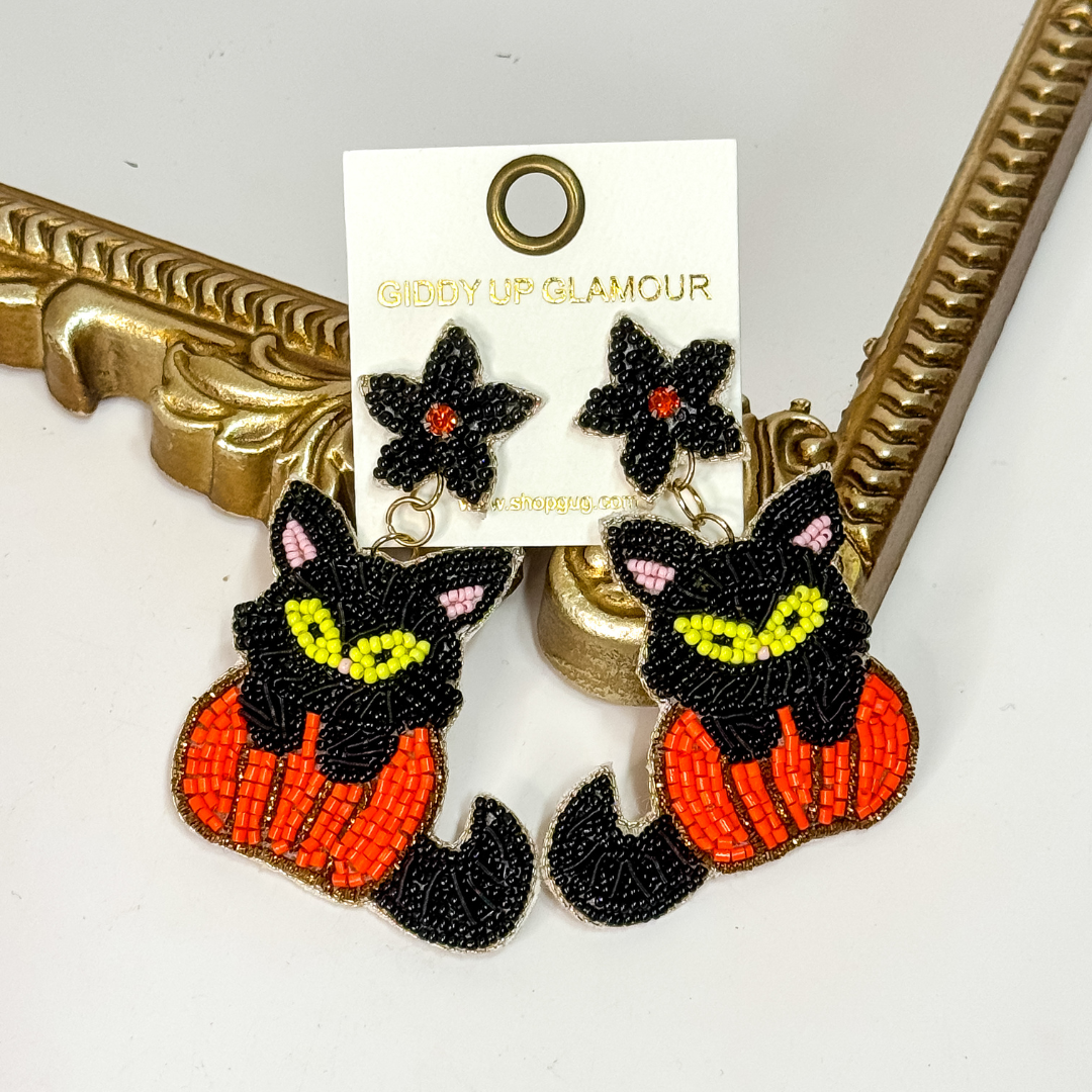 Beaded Halloween earrings with black cat sitting on a pumpkin, lightweight statement jewelry with flower post.