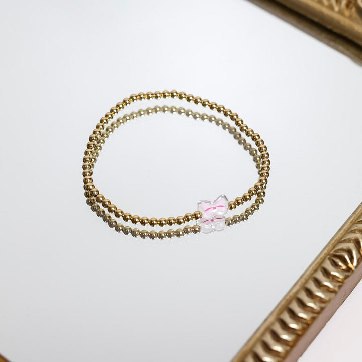 Beaded Blondes | Gold Beaded Bracelet with Pink Bow Charm