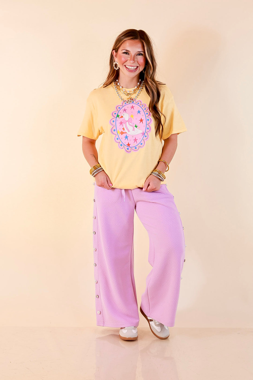 Goose on the Loose Whimsical Pink Background with Stars and Hearts Goose Printed Graphic Tee in Butter Yellow