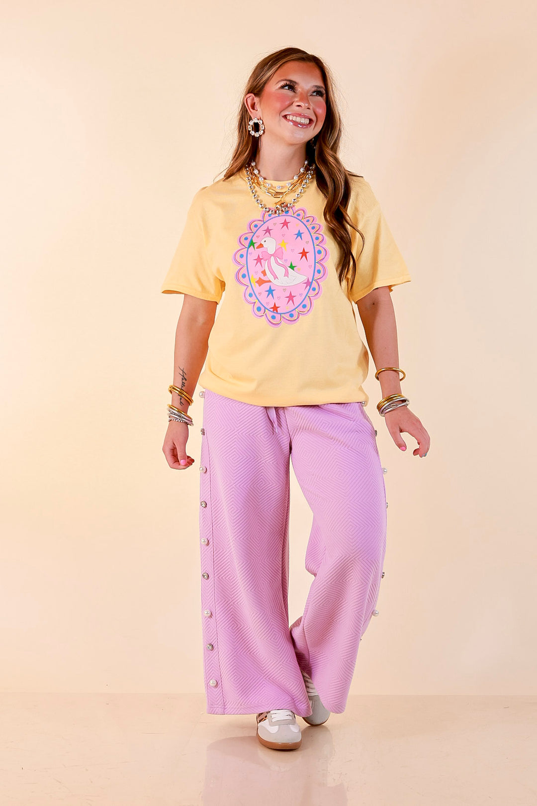 Goose on the Loose Whimsical Pink Background with Stars and Hearts Goose Printed Graphic Tee in Butter Yellow