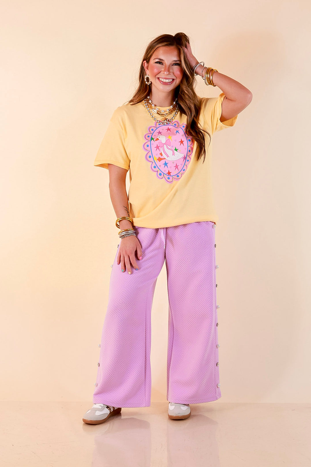 Goose on the Loose Whimsical Pink Background with Stars and Hearts Goose Printed Graphic Tee in Butter Yellow