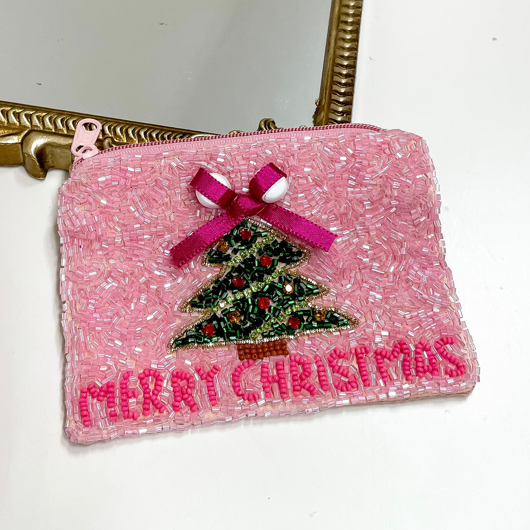 Pink beaded pouch with Christmas tree and 'Merry Christmas' text, attached to a gold frame.