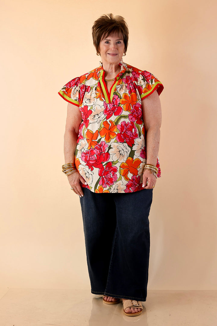 Spring Symphony Floral Print Flutter Sleeve Top with Contrast Trim Split Neckline in Pink and Orange