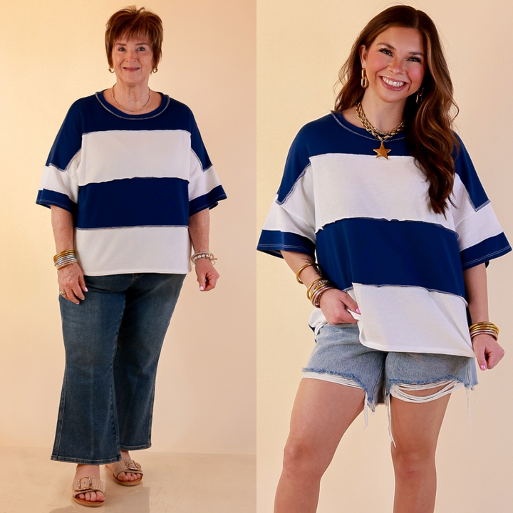 Models are wearing Color Block Rugby Style Wide Stripe Relaxed Short Sleeve Top in Navy Blue with Jeans against a beige backdrop. 