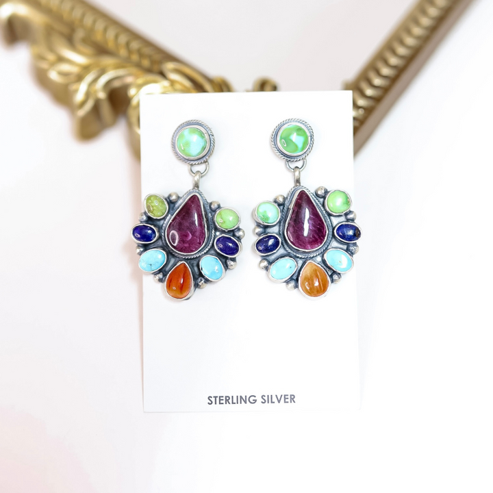 Native American handcrafted sterling silver earrings with turquoise, lapis, Sonoran gold, and orange & purple spiny oyster stones, designed by artist Travis J.