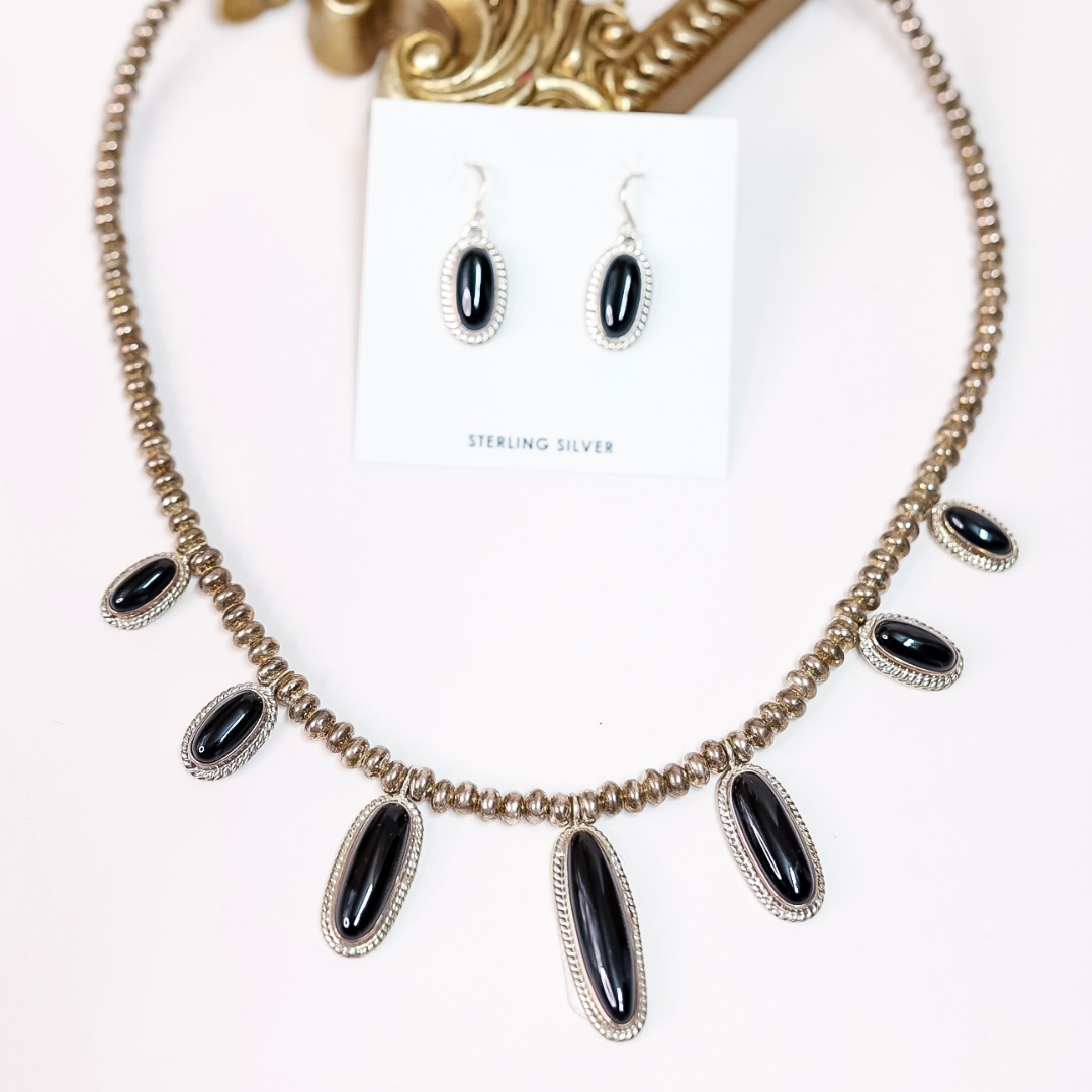 Sterling silver and black onyx necklace with matching dangle earrings by Native American artist Ty Fransisco, featuring a 19-inch chain with 2-inch extender and artist hallmark stamp “T”.
