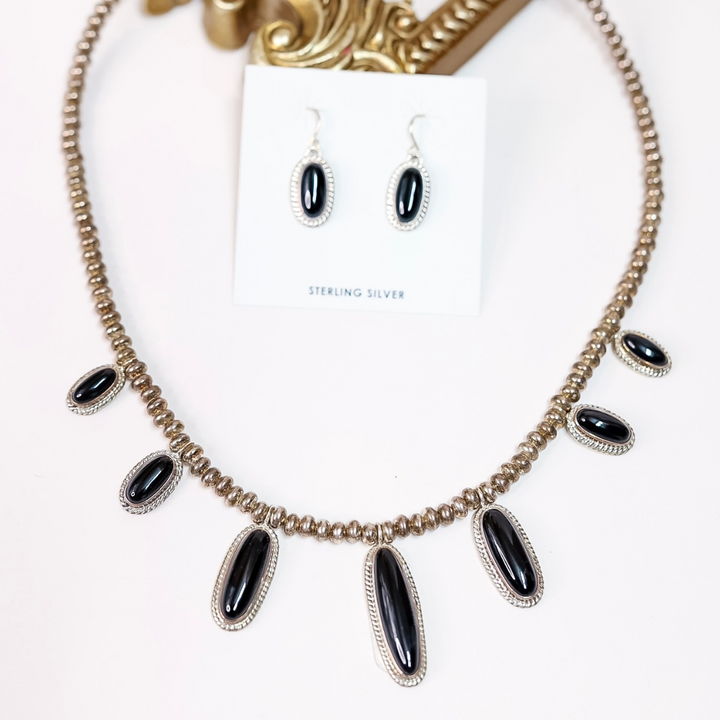 Sterling silver and black onyx necklace with matching dangle earrings by Native American artist Ty Fransisco, featuring a 19-inch chain with 2-inch extender and artist hallmark stamp “T”.