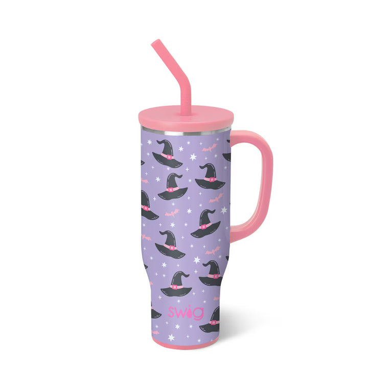 Purple tumbler with witch hats and pink handle and straw on a white background