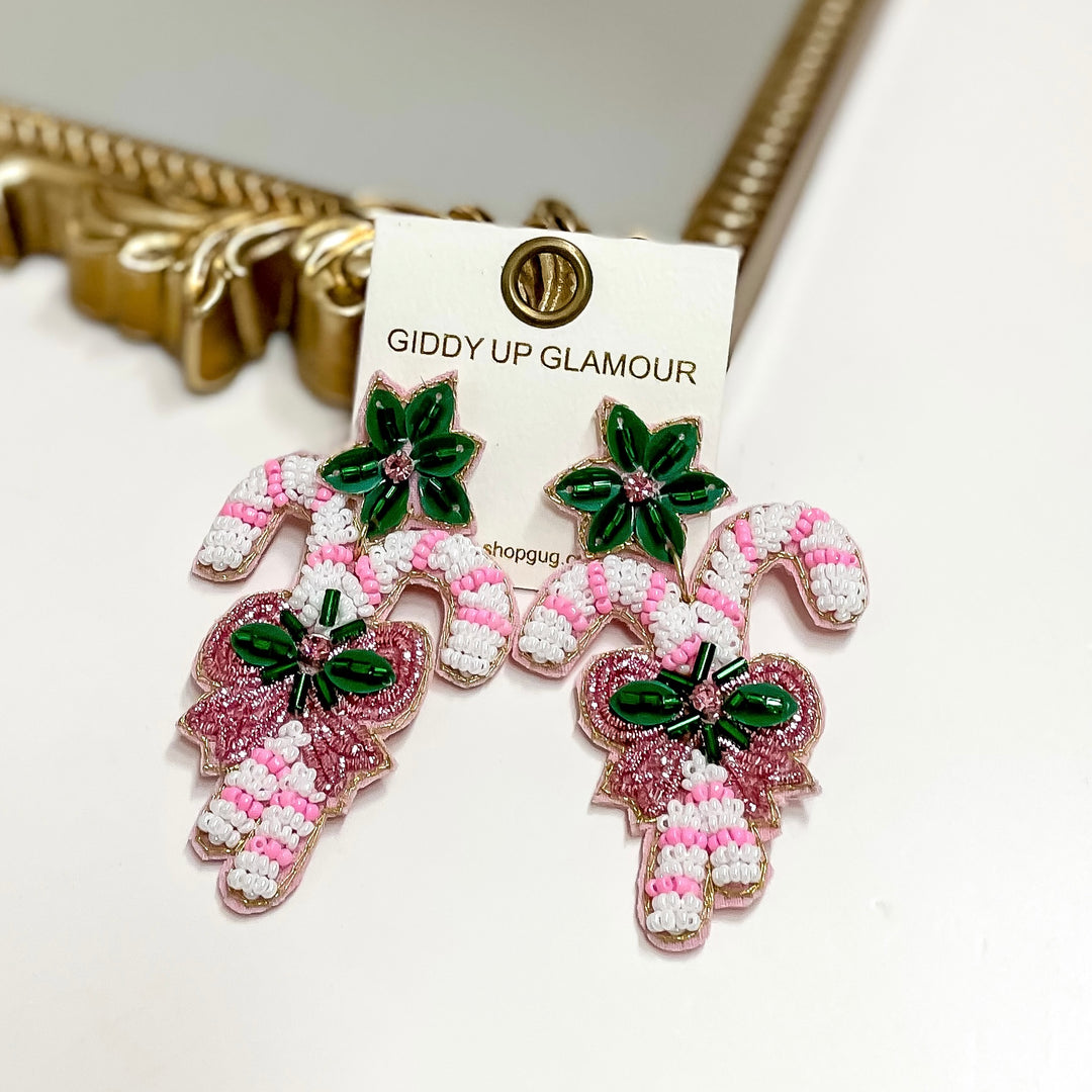 Decorative earrings on a 'Giddy Up Glamour' branded card.