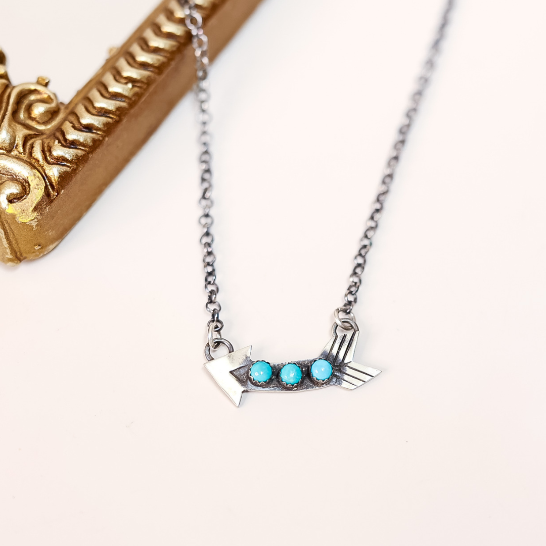Silver necklace with turquoise stones on a white background