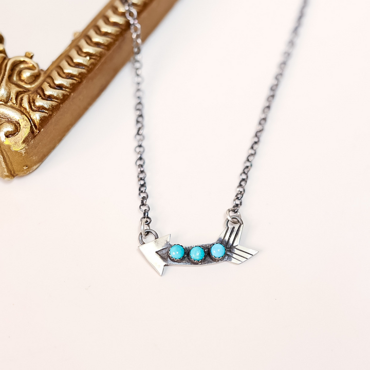 Silver necklace with turquoise stones on a white background