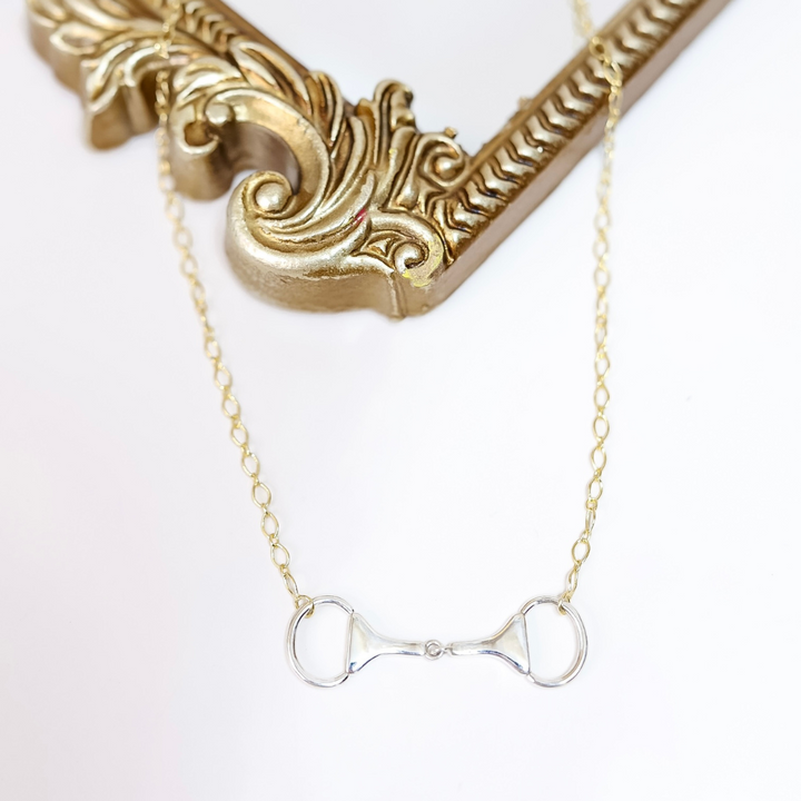 Close-up of Sterling Silver and 14K Gold plated horse bit necklace with snaffle bit pendant on adjustable chain, handmade and stamped by artist "HaDa".