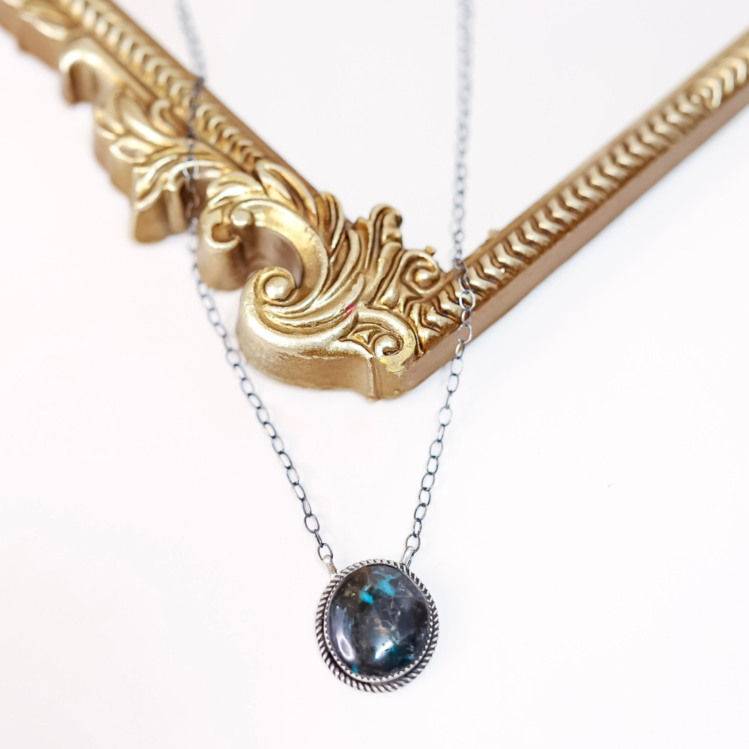 Sterling silver Blue Moon Turquoise necklace by Tia Long featuring a round natural stone pendant with black and blue marbling on silver chain.
