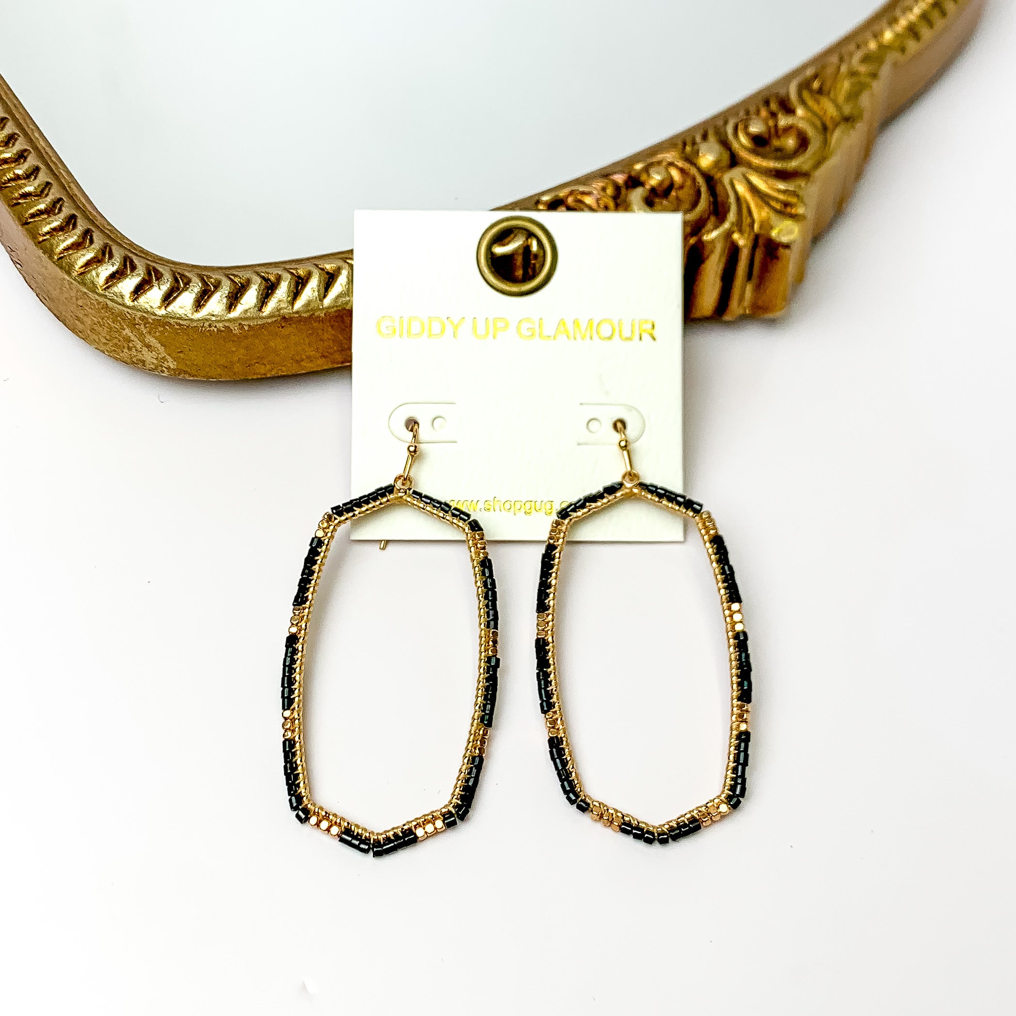 Black Beaded Open Large Drop Earrings with Gold Tone Accessory. Pictured on a white background with a gold frame through.