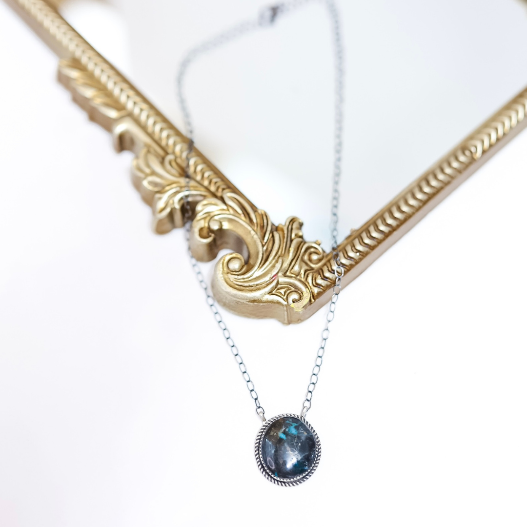 Sterling silver Blue Moon Turquoise necklace by Tia Long featuring a round natural stone pendant with black and blue marbling on silver chain.