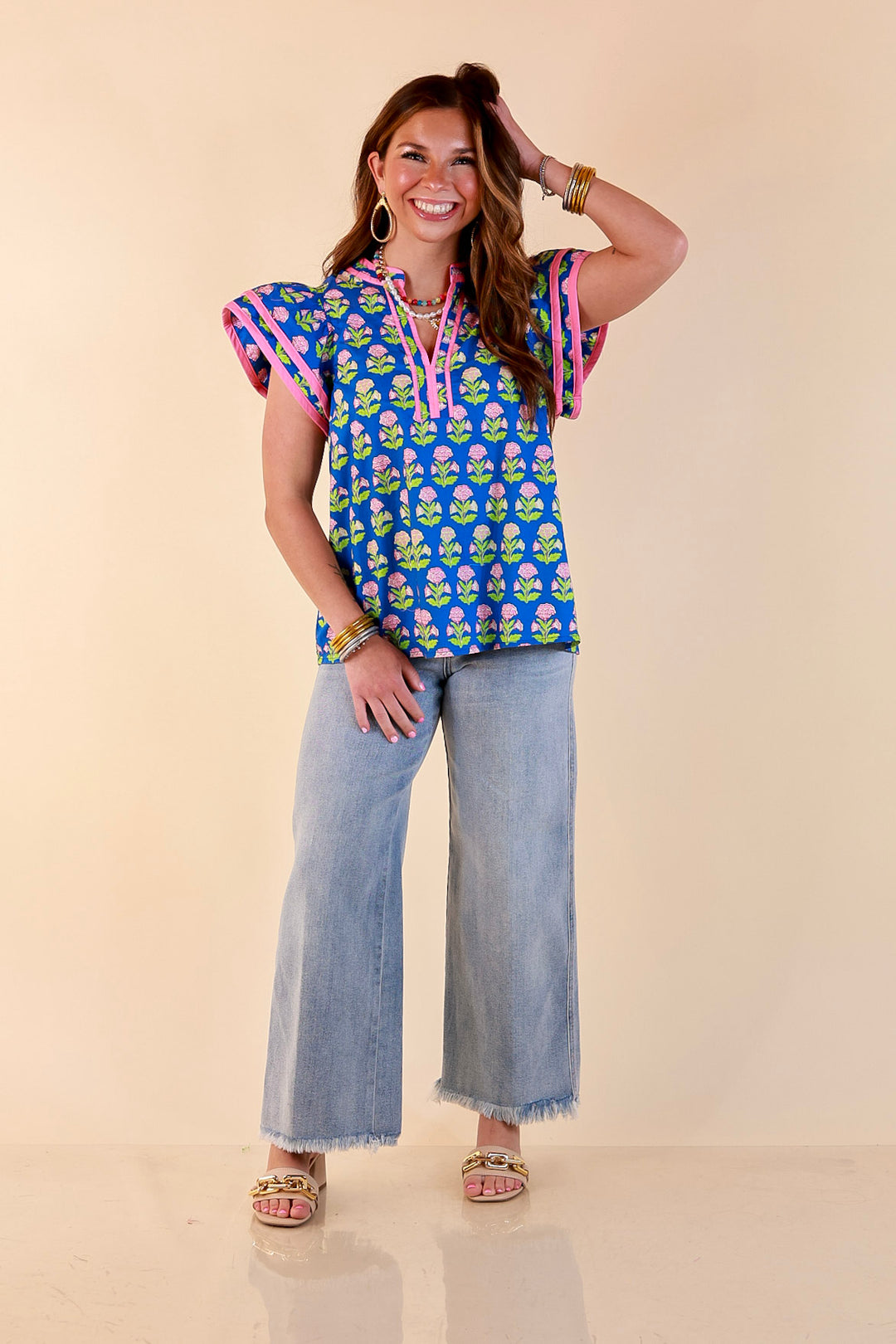 Fresh Perspective V Neck Floral Print Top with Ruffle Cap Flutter Sleeves and Contrast Trim in Royal Blue
