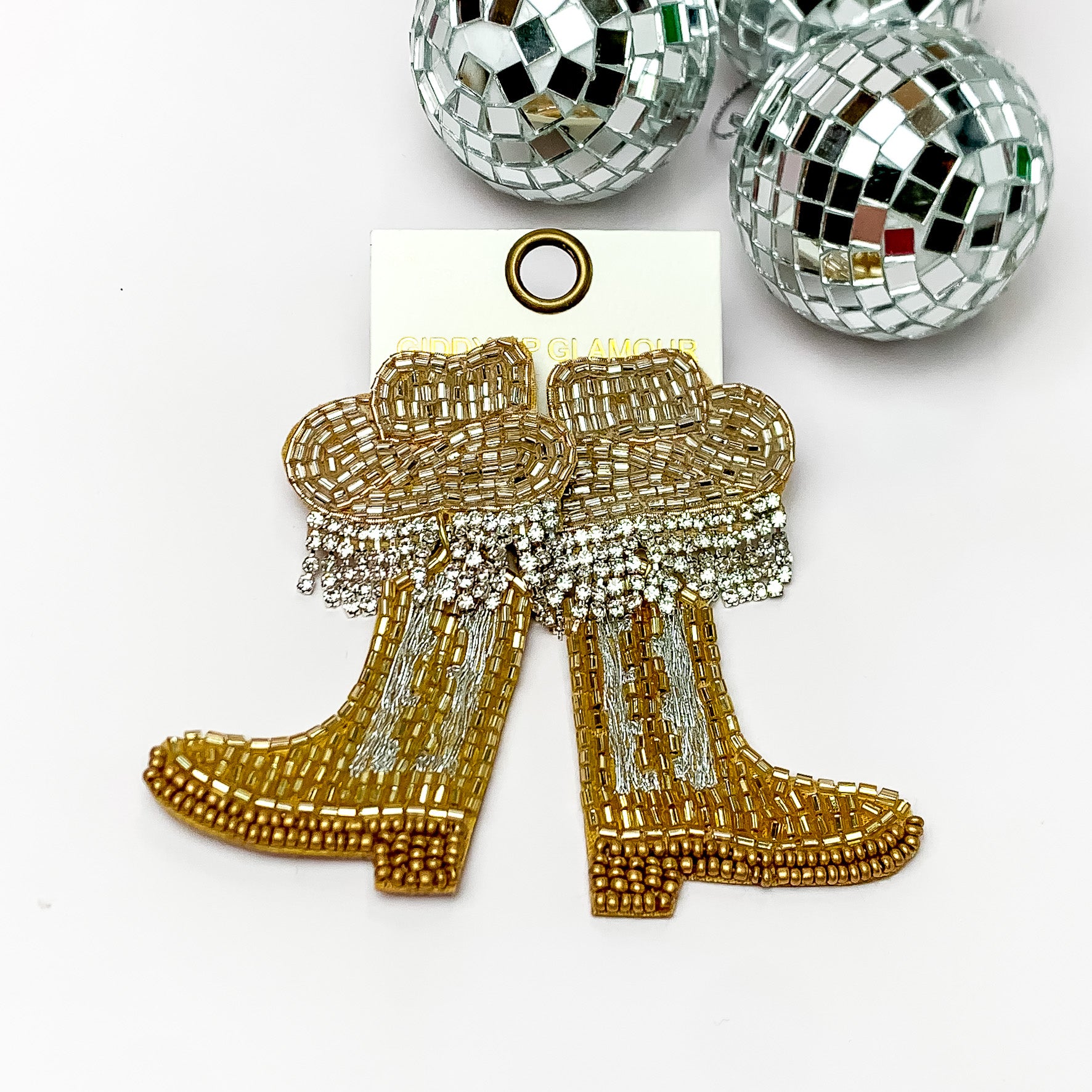 Beaded Gold Cowboy Boot Earrings with Gold Hat Studs. Pictured on a white background with disco balls in the top right.