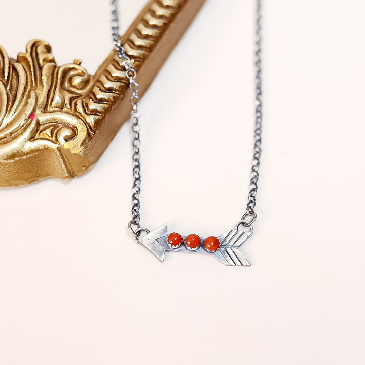 Necklace with red beads on a white background
