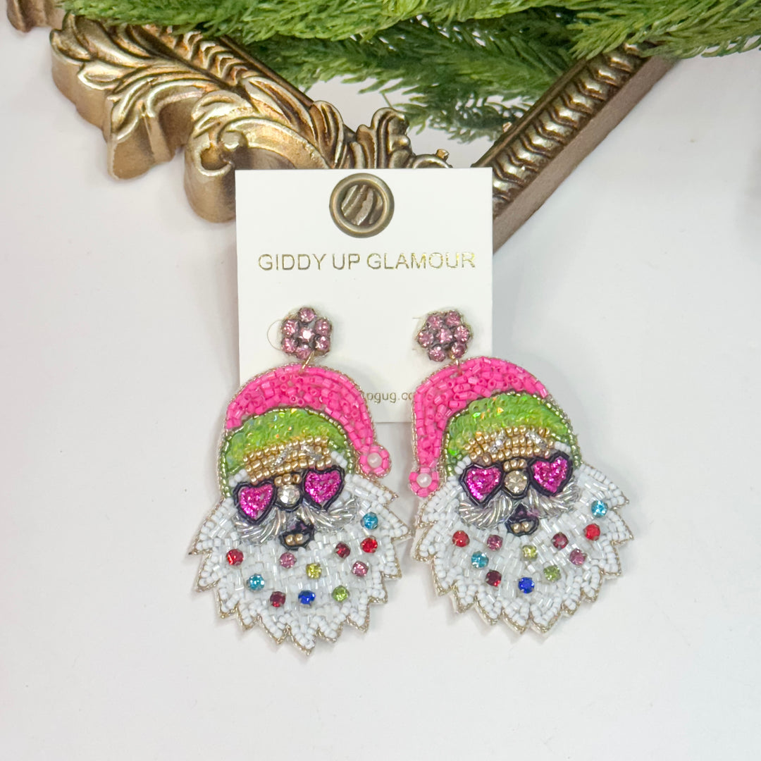 Colorful gnome-themed earrings on a 'Giddy Up Glamour' card with a decorative gold frame in the background.