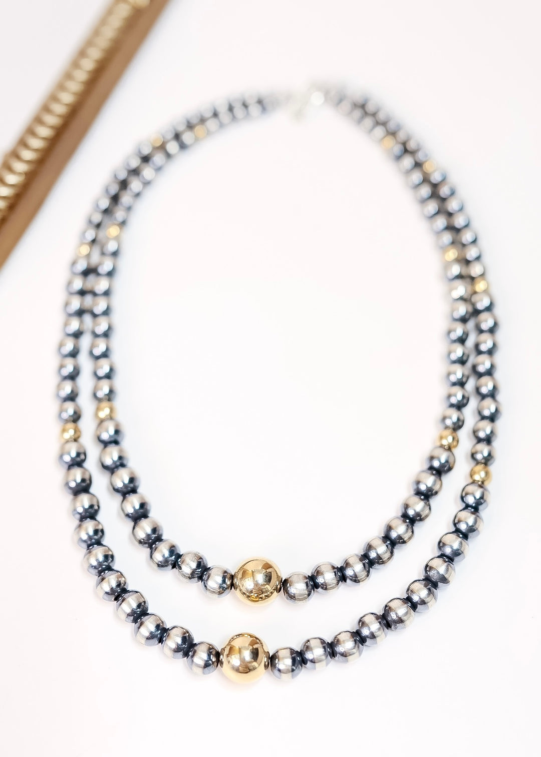 Handmade Navajo pearl and 14K gold necklace with graduated sterling silver beads and center gold accent, available in 16 and 18 inch lengths.