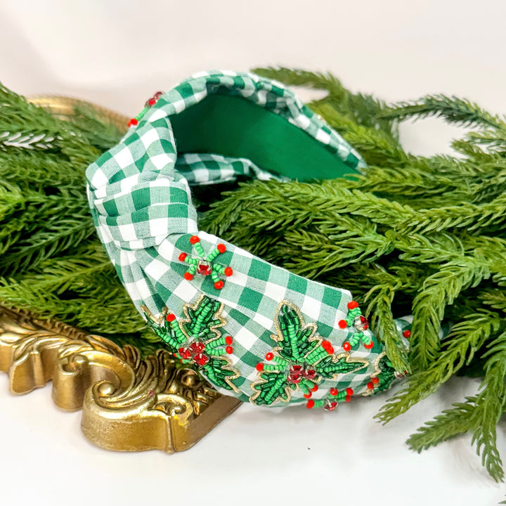 Green checkered headband with decorative elements on a white background