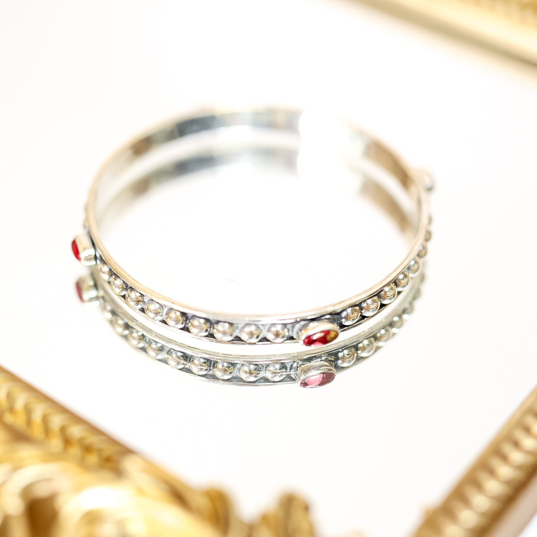 Handmade sterling silver bangle featuring four pink Dahlia Rose stones on each, with beaded detailing.
