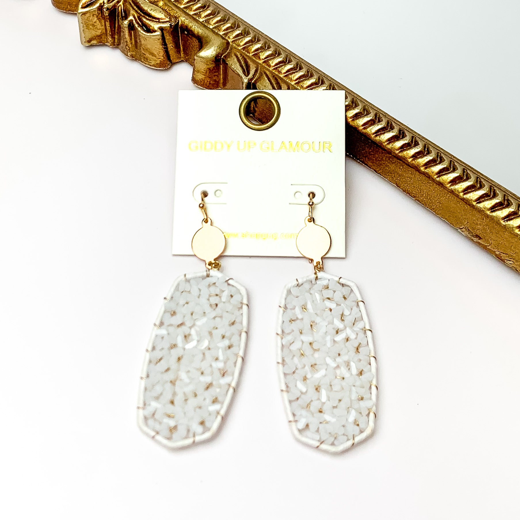 White Large Drop Earring with Gold Tone Accessory. Pictured on a white background with a gold frame through it