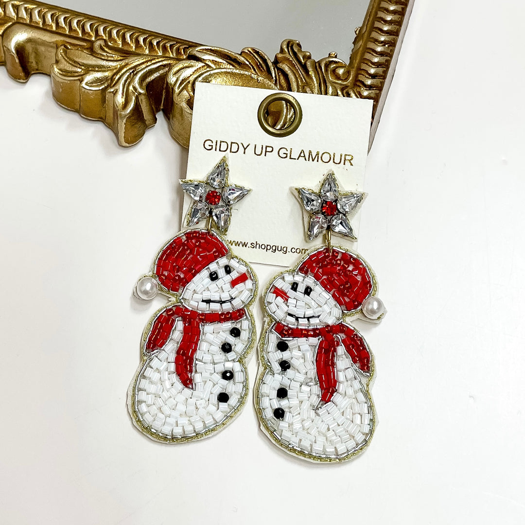 Snowman-themed earrings on a 'Giddy Up Glamour' branded card with a decorative gold frame.