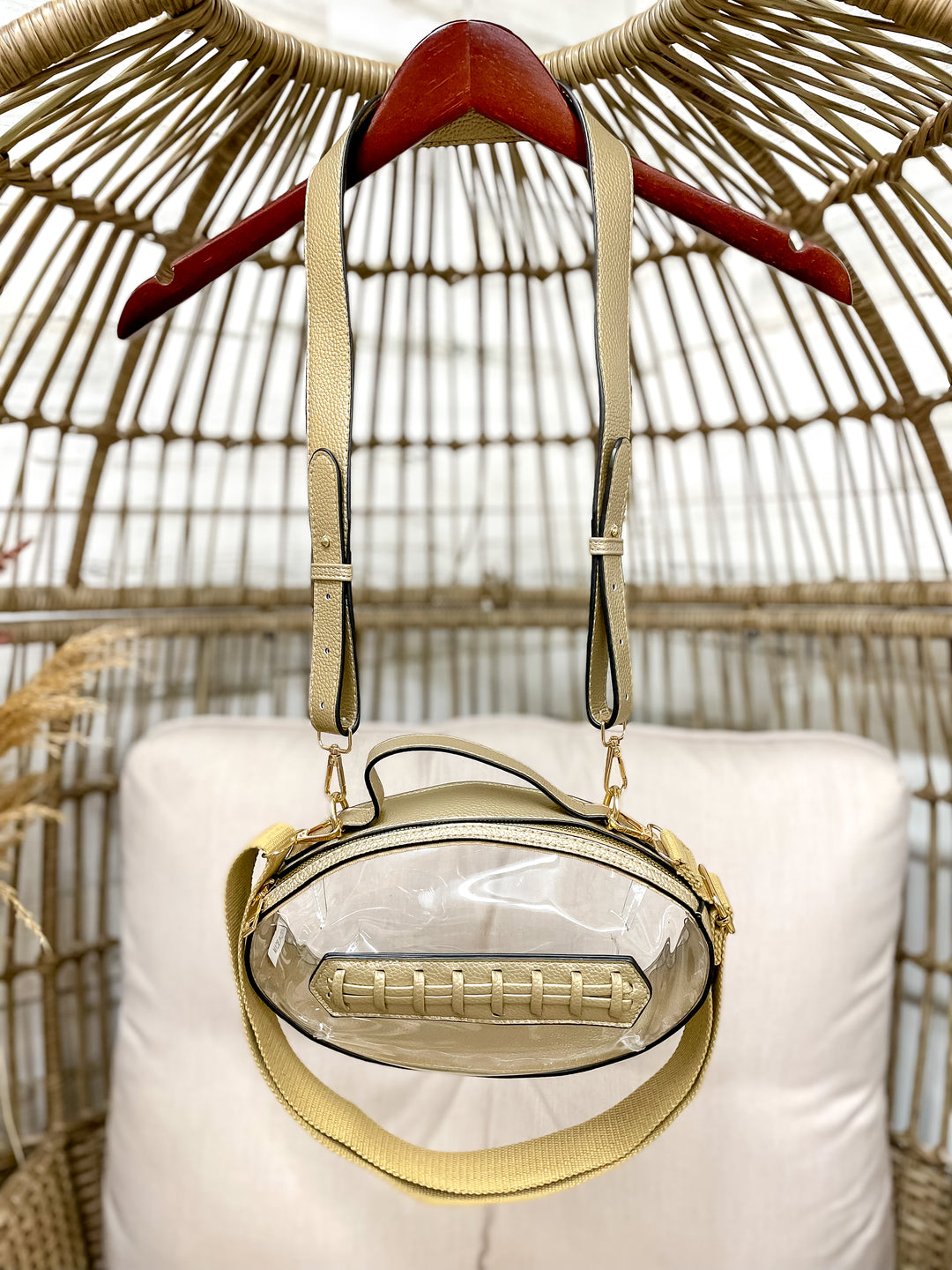 Clear football-shaped stadium bag with faux leather trim and gold hardware from Giddy Up Glamour.