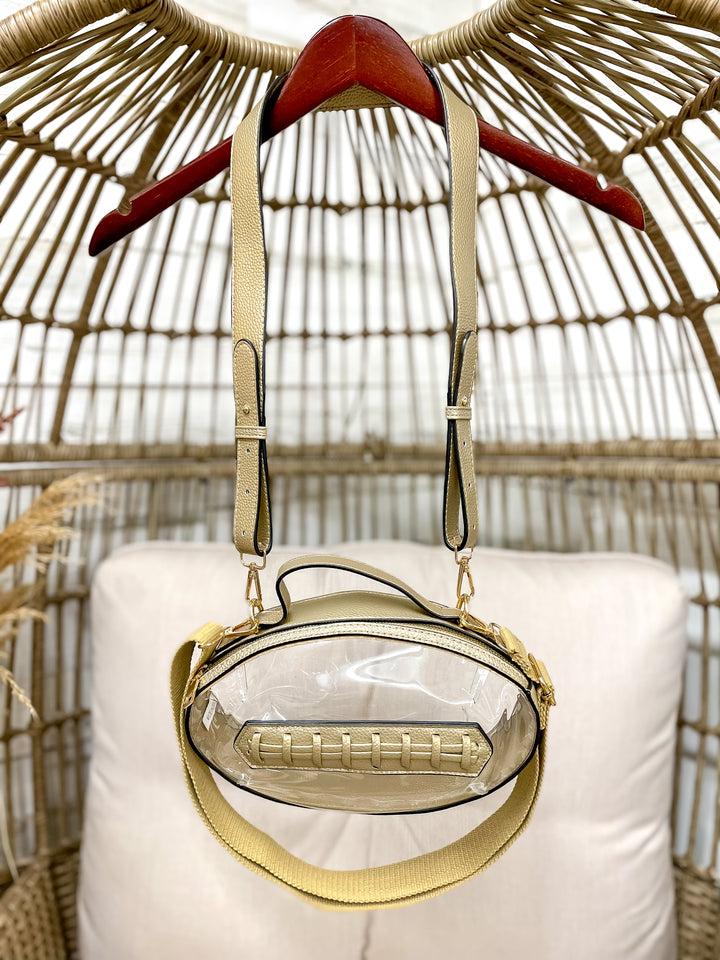 Clear football-shaped stadium bag with faux leather trim and gold hardware from Giddy Up Glamour.