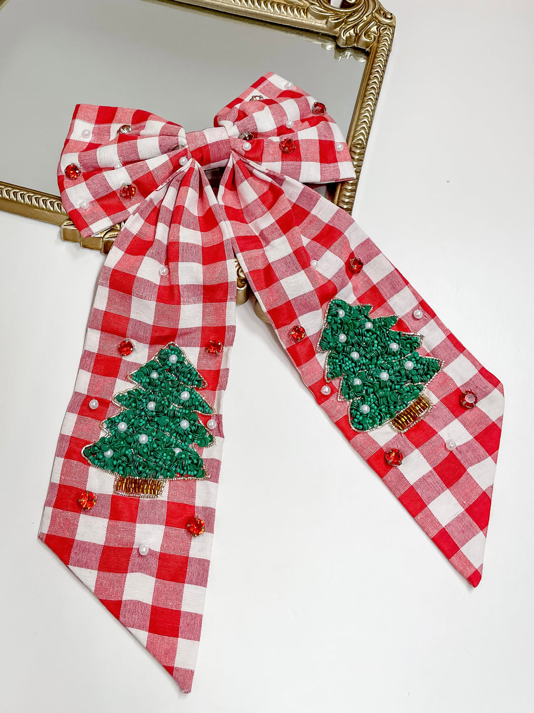 Red gingham Christmas hair bow with beaded green trees, pearls, and red crystals, festive holiday accessory.