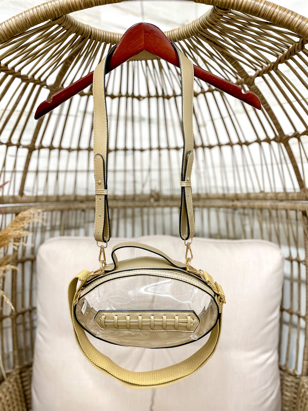 Clear football-shaped stadium bag with faux leather trim and gold hardware from Giddy Up Glamour.