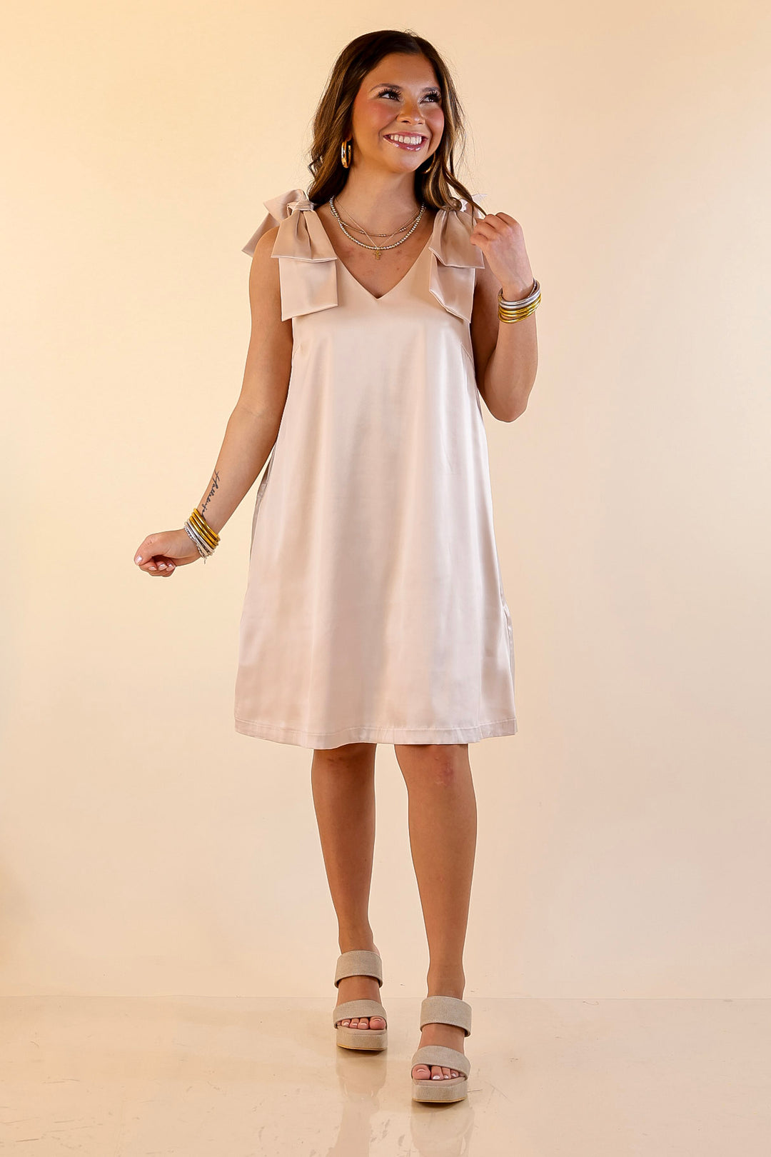 Satin Soirée V Neck Mini Dress with Bow Strap Detailing in Champagne