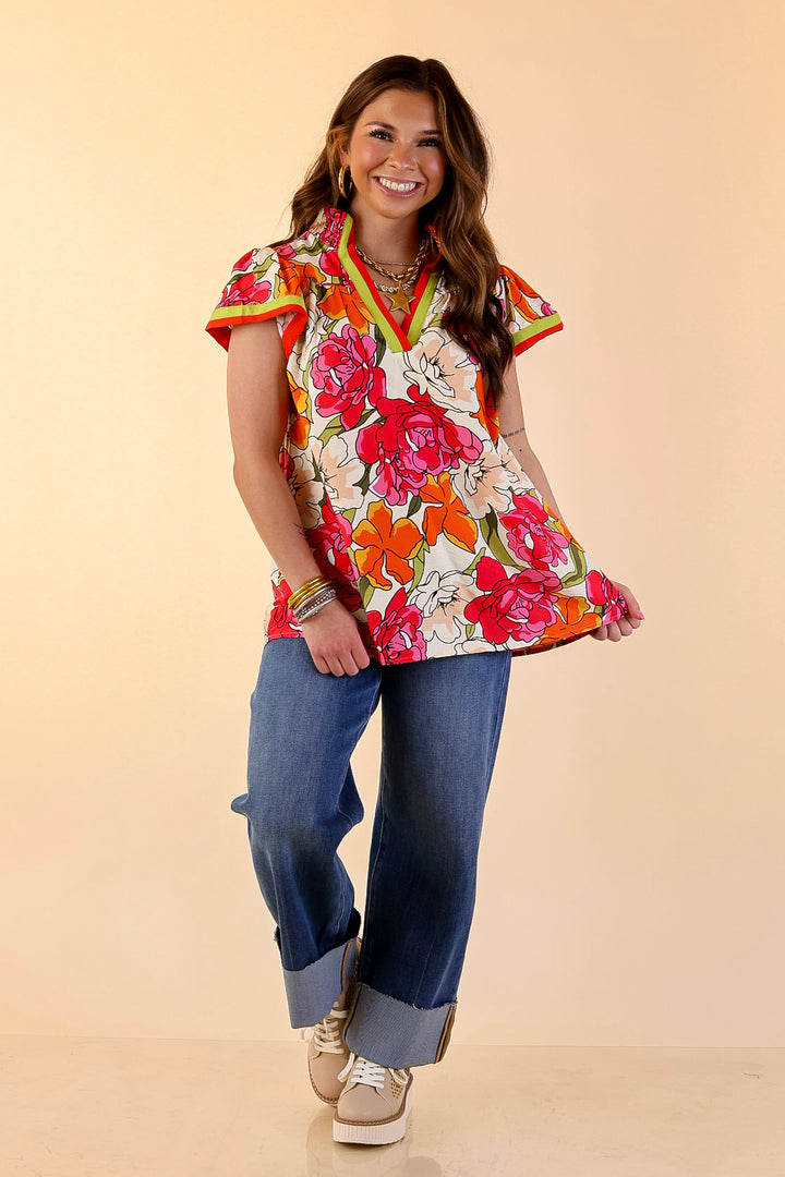 Spring Symphony Floral Print Flutter Sleeve Top with Contrast Trim Split Neckline in Pink and Orange