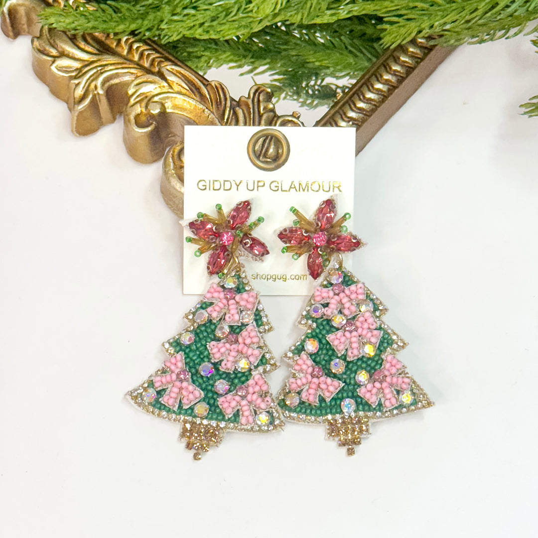 Decorative earrings on a 'Giddy Up Glamour' branded card with a gold frame and greenery in the background.
