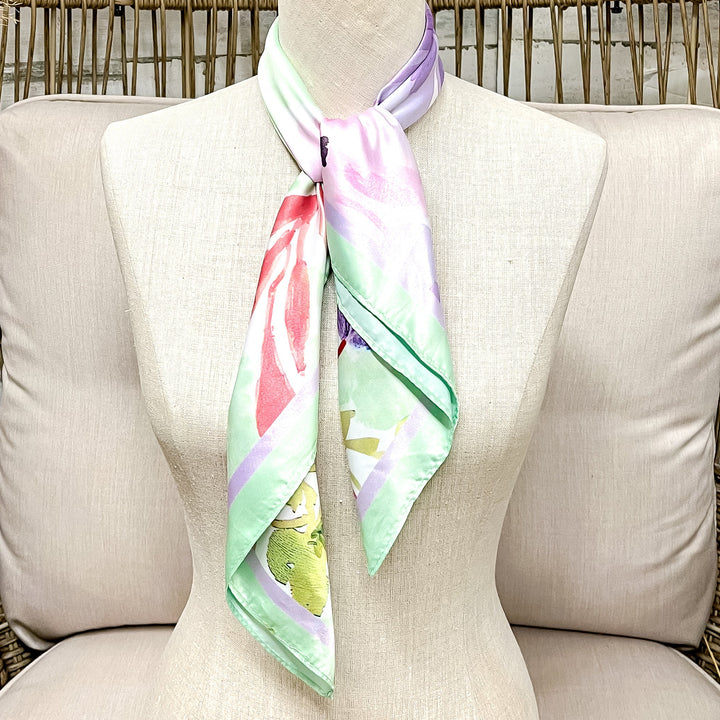 Mannequin wearing a colorful scarf on a wicker chair