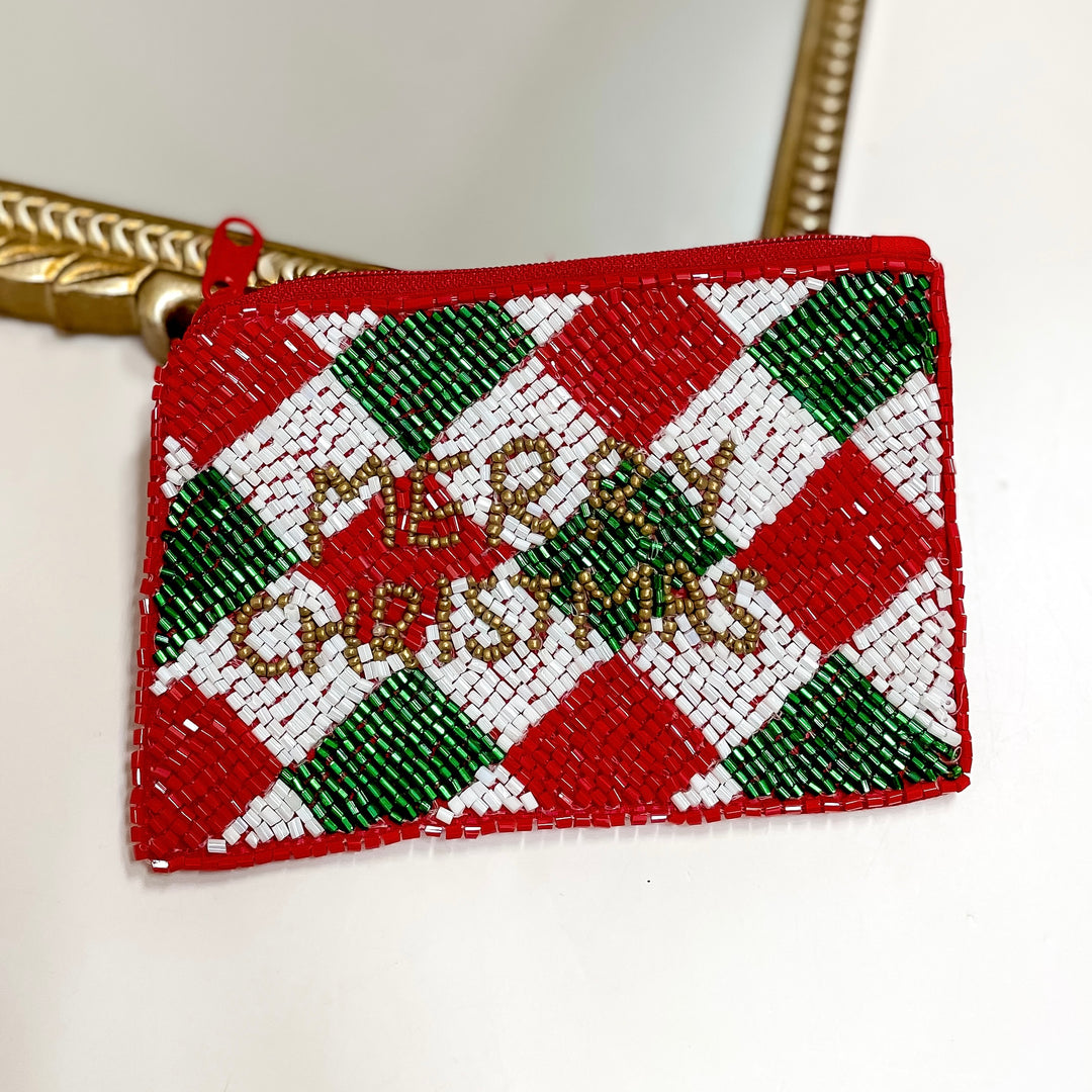 Beaded pouch with red, green, and white pattern on a white background