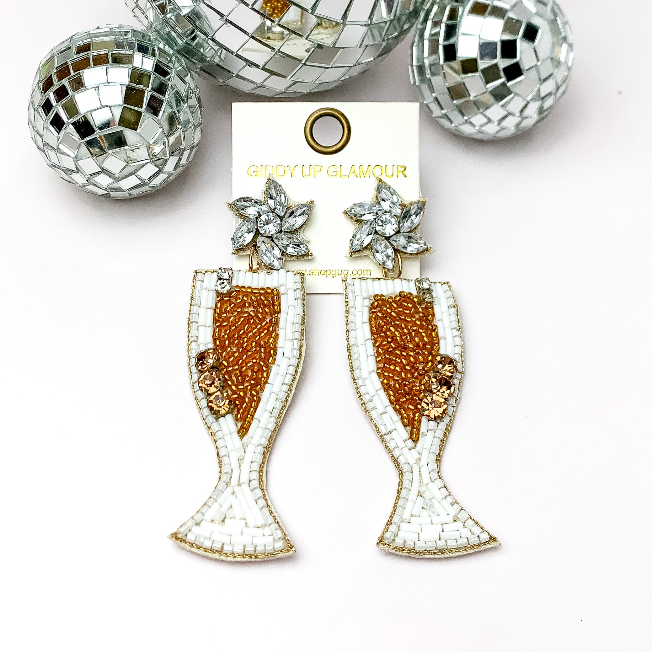 Celebration Beaded Champagne Flutes in White and Gold. Pictured on a white background with disco balls at the top.