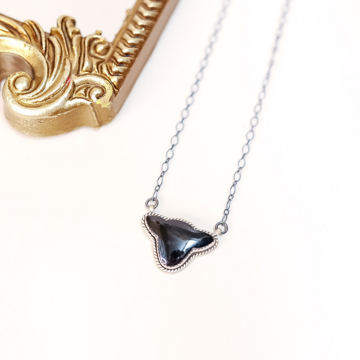 Necklace with a triangular pendant on a white background
