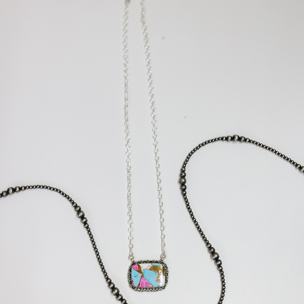 Necklace with a small square pendant featuring colorful characters on a white background