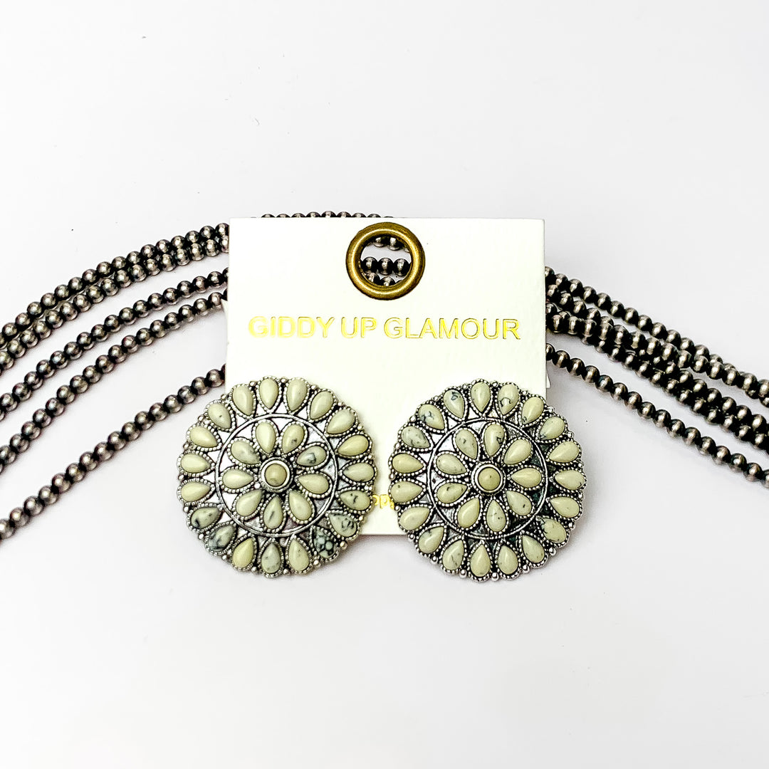 Silver Tone Circle Cluster Stud Earrings with Ivory Stones. Pictured on a white background with beads through the back.