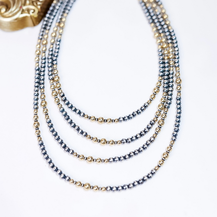 Layered Navajo pearl necklace with 5mm sterling silver beads and 14K gold accents, available in 18, 20, 22, and 24 inch lengths.