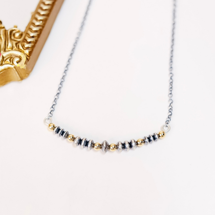 Adjustable Navajo pearl bar necklace with 6mm to 8mm saucer beads and 14K gold-filled spacers on a 21-inch sterling silver chain.