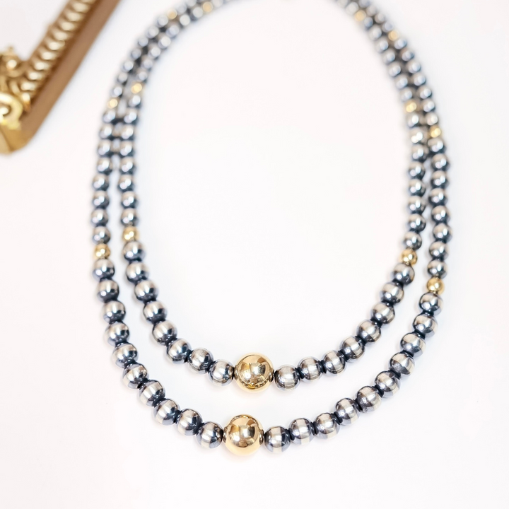 Handmade Navajo pearl and 14K gold necklace with graduated sterling silver beads and center gold accent, available in 16 and 18 inch lengths.