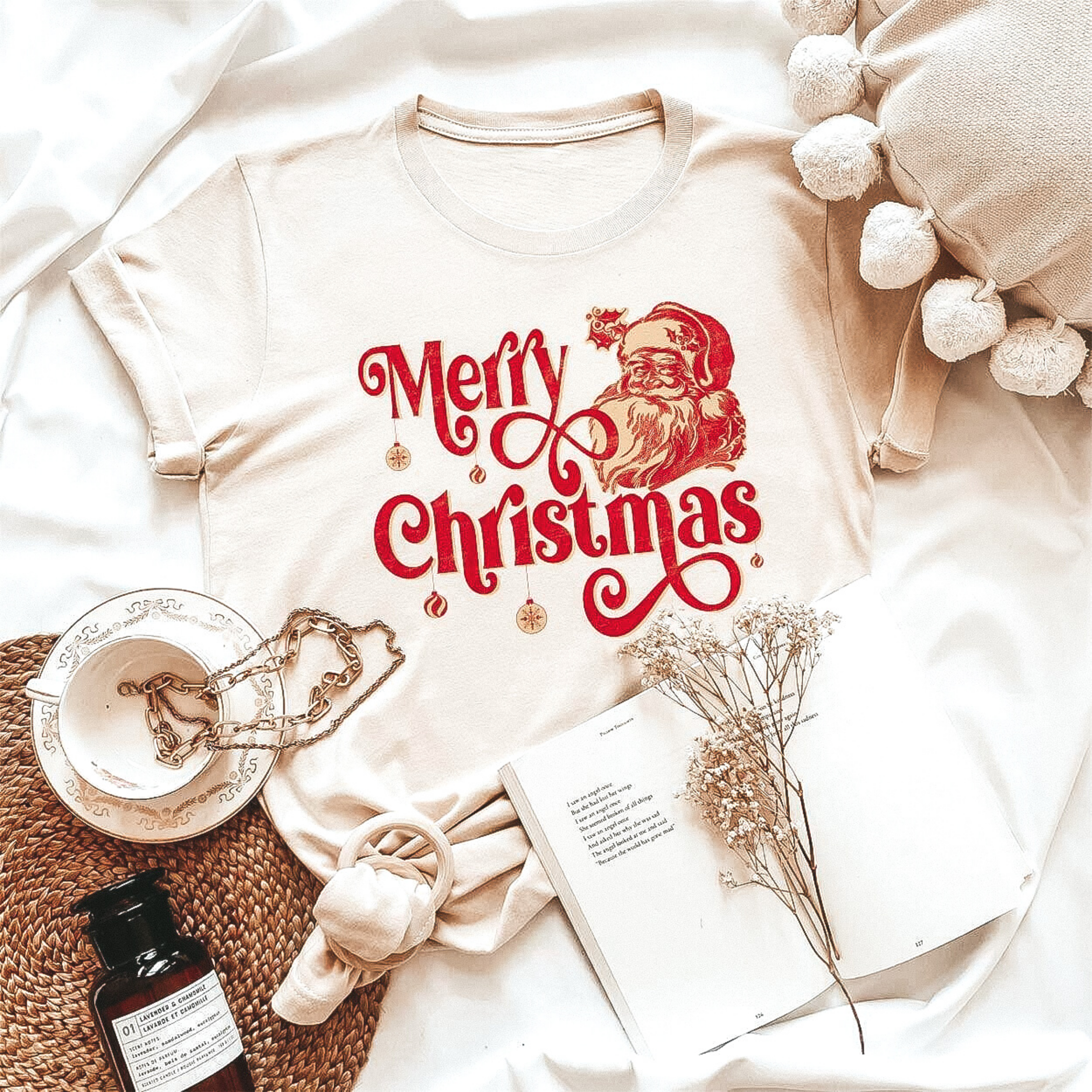 Short sleeve crew neck graphic tee with an image of Santa Clause's head and a graphic that says "Merry Christmas" with ornaments hanging off the letters.