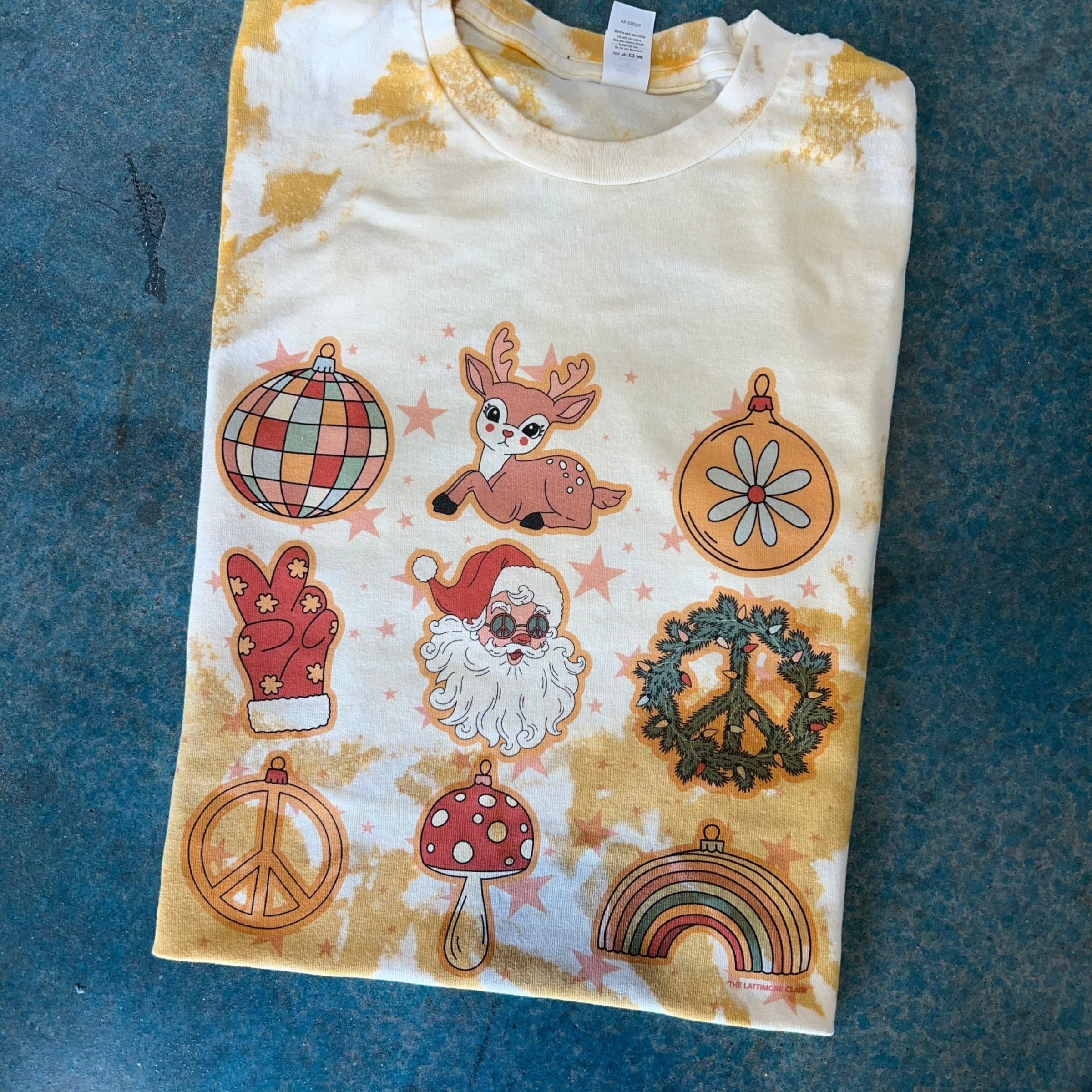 Short sleeve mustard bleached shirt on a blue background with hand drawn Christmas art. 
